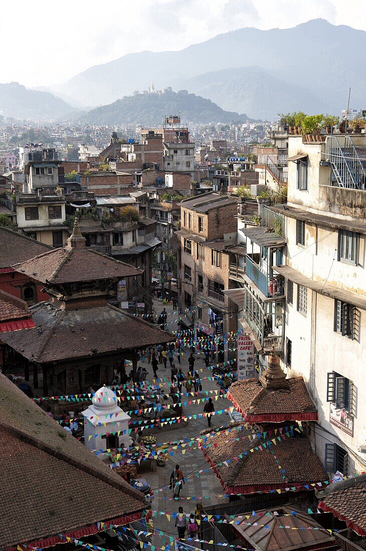 View over narrow streets and rooftops near Durbar Square towards the hilltop temple of Swayambhunath, Kathmandu, Nepal, Asia