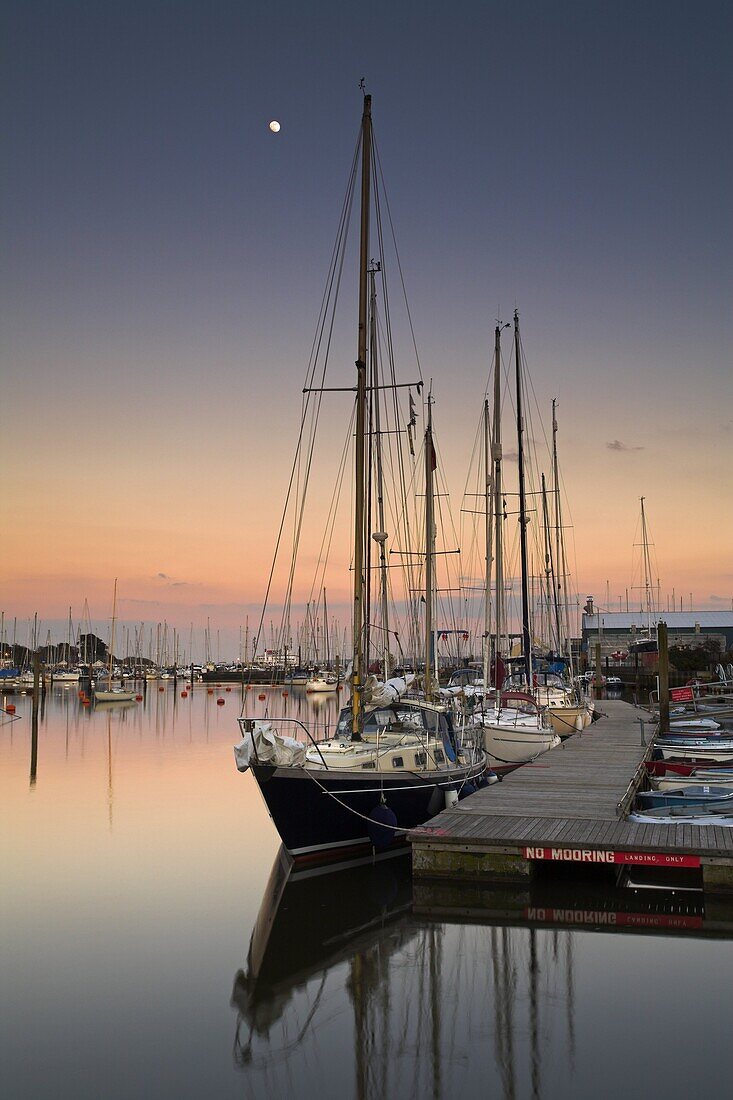 Evening draws in over a calm Lymington harbour, Lymington, Hampshire, England, United Kingdom, Europe