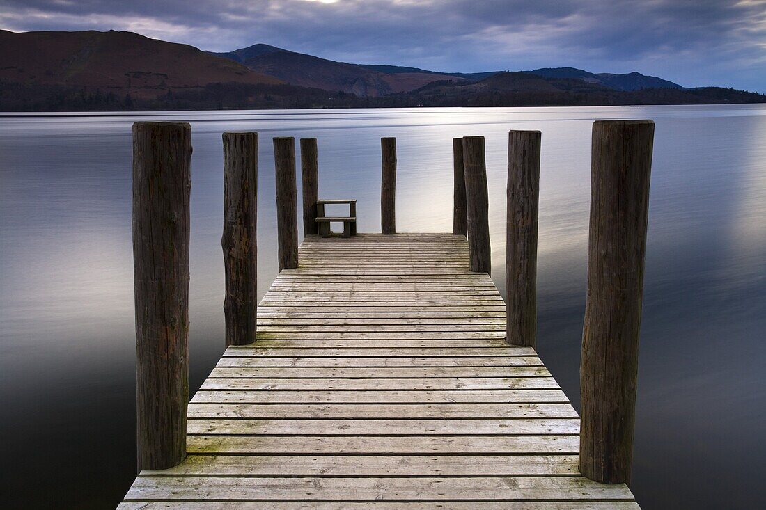 A wooden jetty stretches out into Derwent Water in the Lake District National Park, Cumbria, England, United Kingdom, Europe