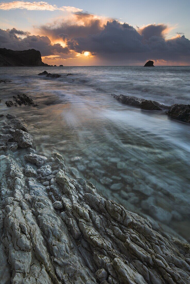 Incoming tide floods the rocky shore at sunrise Man O War Bay, Jurassic Coast, UNESCO World Heritage Site, Dorset, England, United Kingdom, Europe