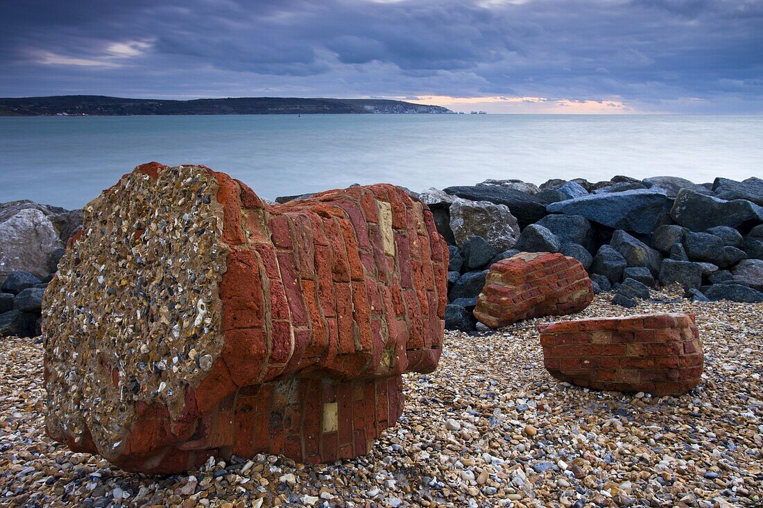 Coastal defences along Hurst Spit. In the distance the Isle of Wight and the Needles, Hampshire, England, United Kingdom, Europe