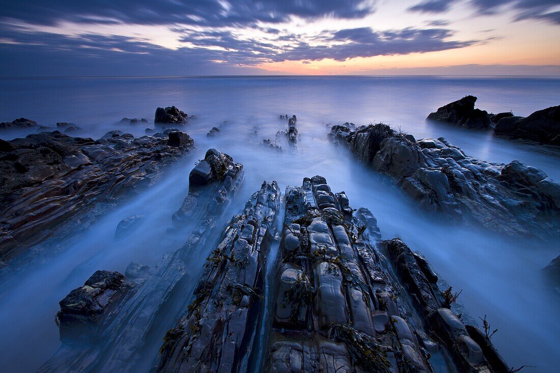 Advancing tide on the rocky ledges of Sandymouth, Cornwall, England, United Kingdom, Europe
