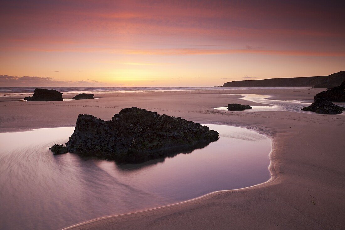 Rockpools on the sandy shores of Bedruthan Steps at sunset Cornwall, England, United Kingdom, Europe