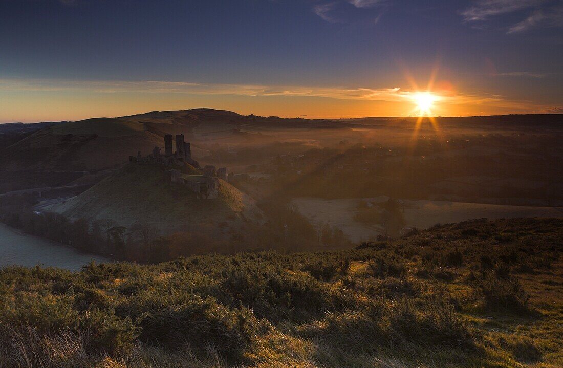 Early morning sunshine warms a chilly morning at Corfe Castle, Dorset, England, United Kingdom, Europe