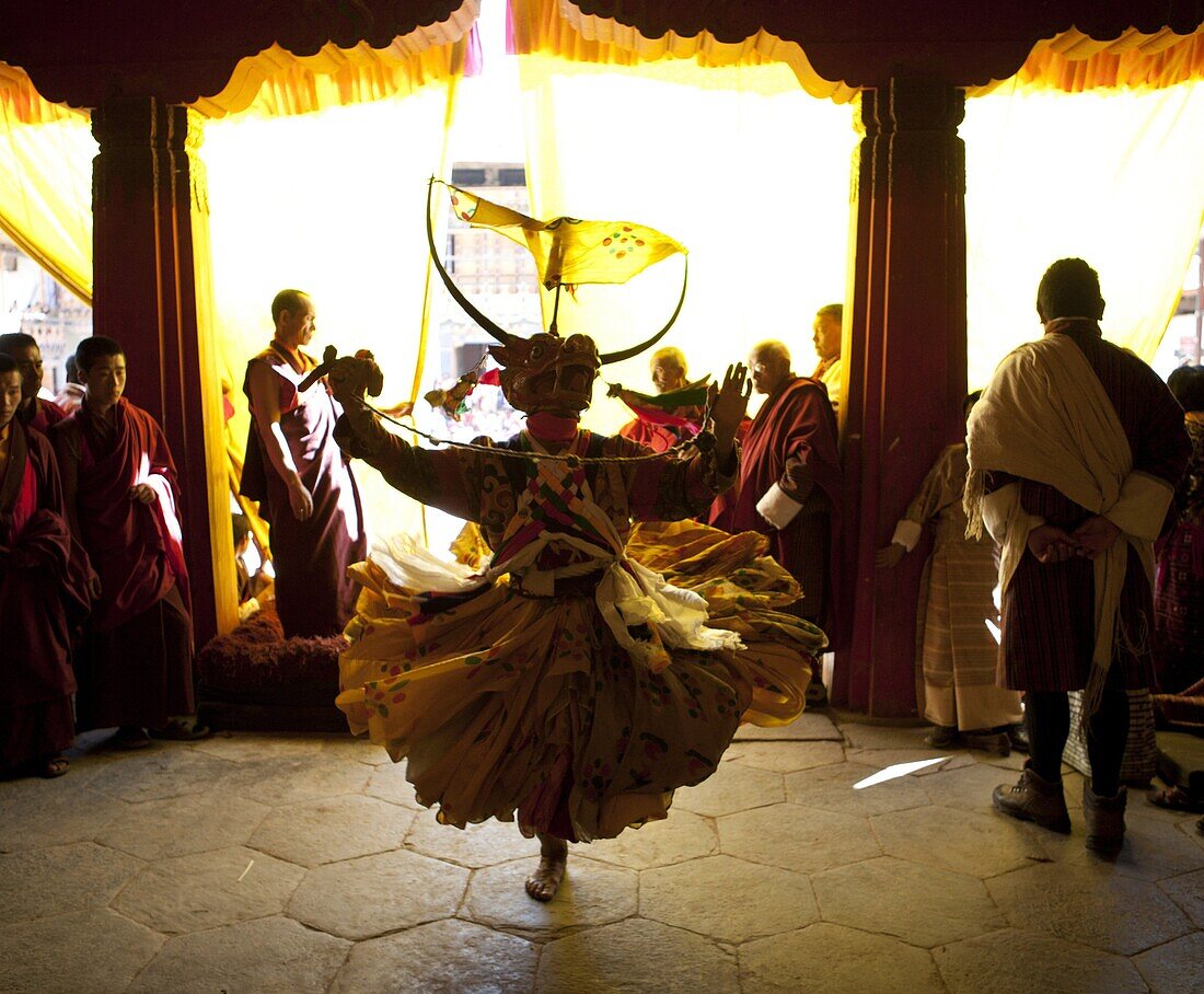 Buddhist monk in costume and mask practising his dance before taking part in a performance at the Gangtey Tsechu at Gangte Goemba, Gangte, Phobjikha Valley, Bhutan, Asia