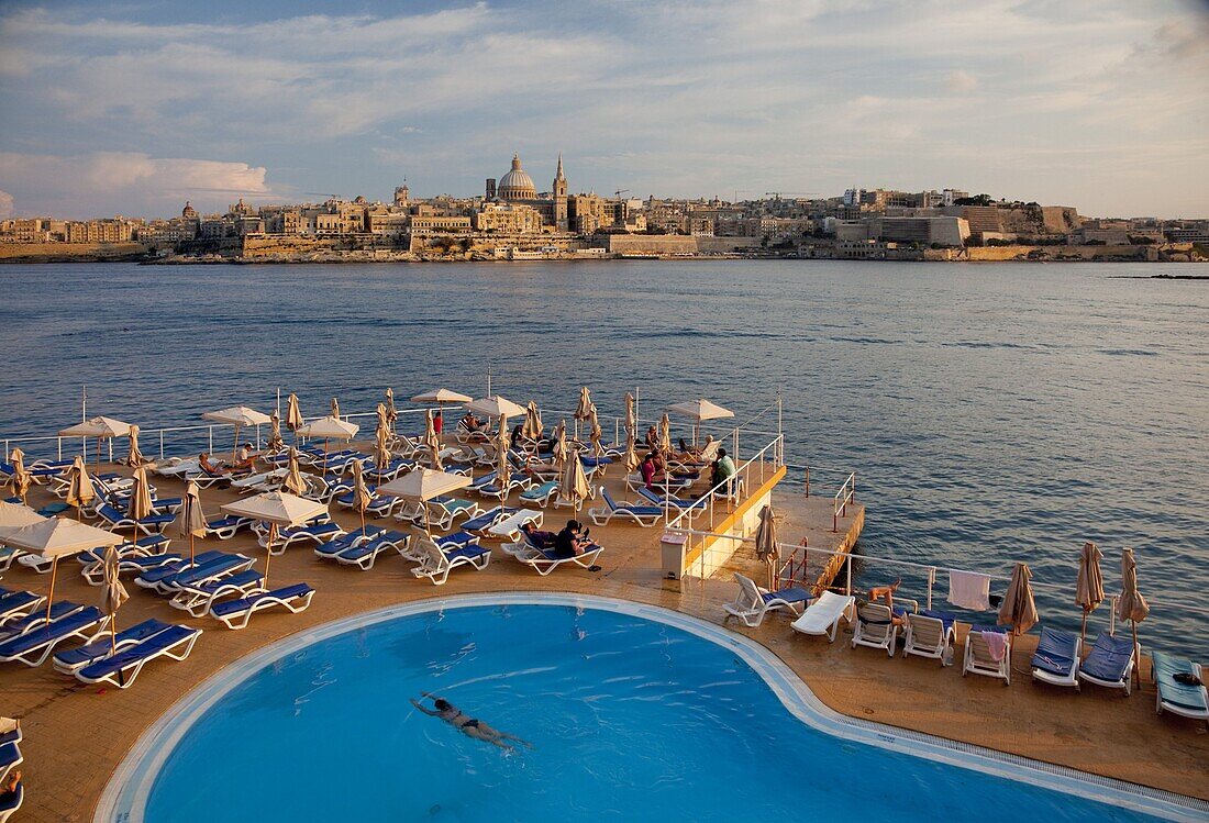 Valletta and dome of Carmelite Church from swimming pool in Sliema, Malta, Mediterranean, Europe