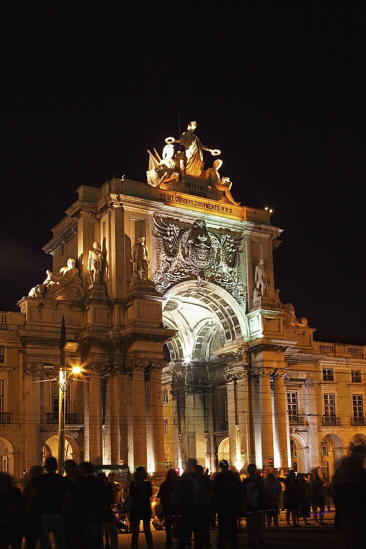 A crowd on Praca do Comercio square for the Oceanos Festival under the illuminated Rua Augusta Arch in central Lisbon, Portugal