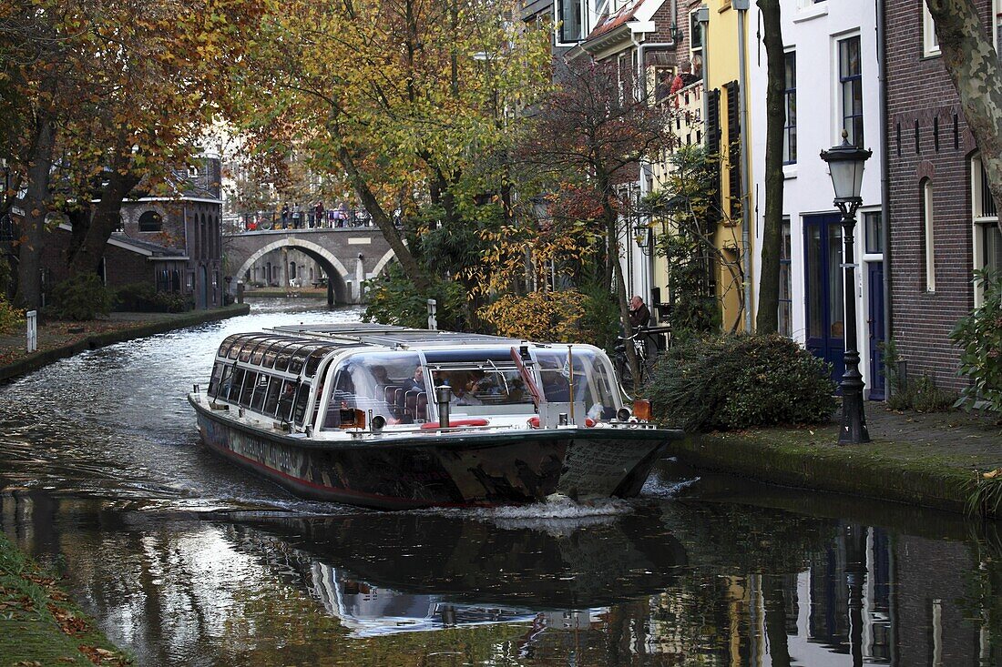 A sightseeing barge tours along the Oudegracht Canal in the Dutch city of Utrecht, Utrecht Province, Netherlands, Europe