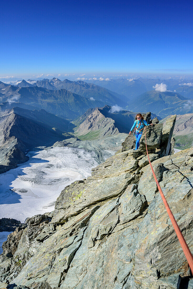 Woman climbing ridge Stuedlgrat towards Grossglockner, Stuedlgrat, Grossglockner, High Tauern, East Tyrol, Austria