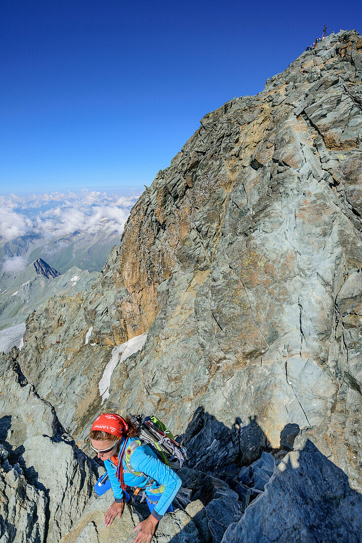 Woman descending over normal route from Grossglockner, Grossglockner, High Tauern, East Tyrol, Austria