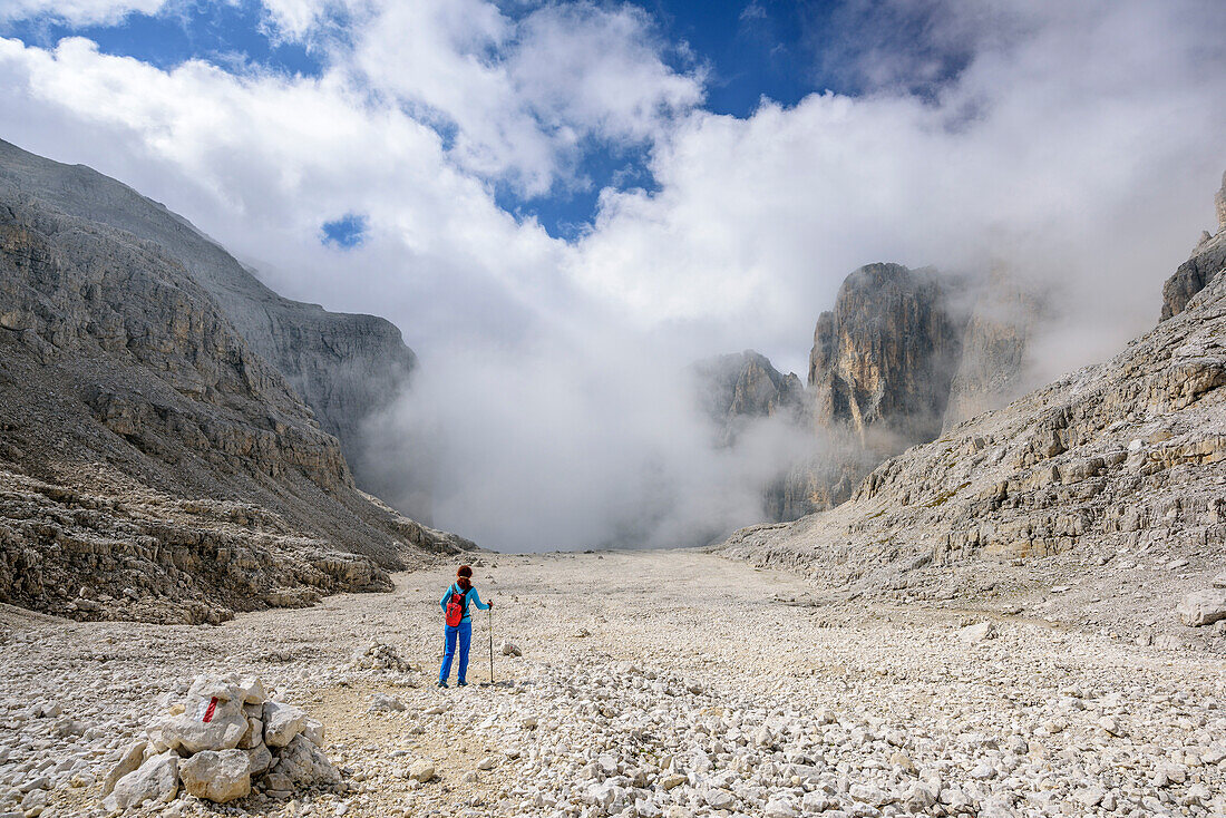 Woman hiking through stony valley, Val Pradidali, Pala range, Dolomites, UNESCO World Heritage Dolomites, Trentino, Italy