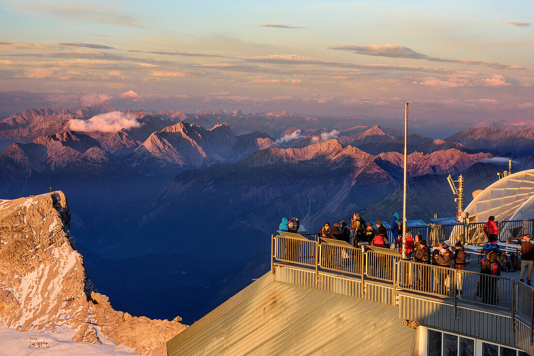 Schneefernerkopf and terrace of hut Muenchner Haus in morning light, Lechtal Alps and Verwall range in background, from Zugspitze, Wetterstein range, Upper Bavaria, Bavaria, Germany