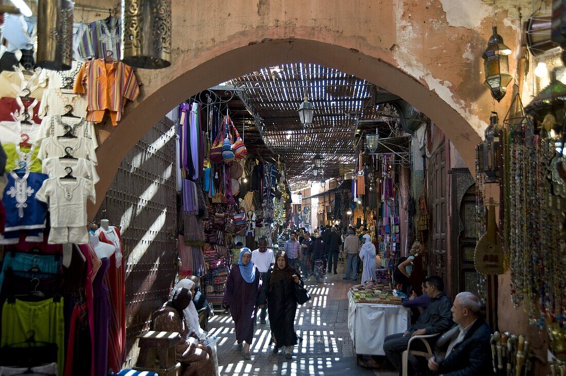 The view through an arch of shoppers in the souk in Marrakech, Morocco, North Africa, Africa