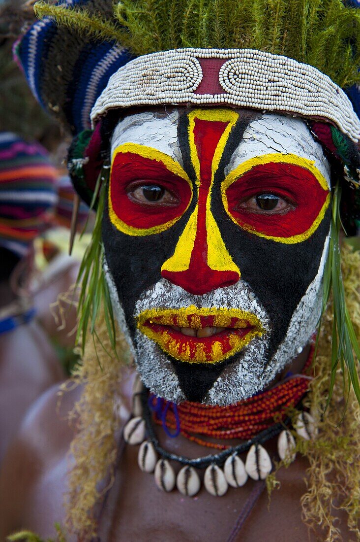 Colourfully dressed and face painted local tribes celebrating the traditional Sing Sing in Enga, Papua New Guinea, Melanesia, Pacific
