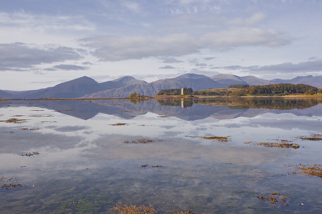 Castle Stalker reflecting into the waters of Loch Laich, Argyll and Bute, Scotland, United Kingdom, Europe
