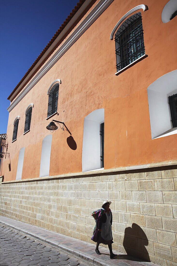 Woman walking along street, Potosi, UNESCO World Heritage Site, Bolivia, South America