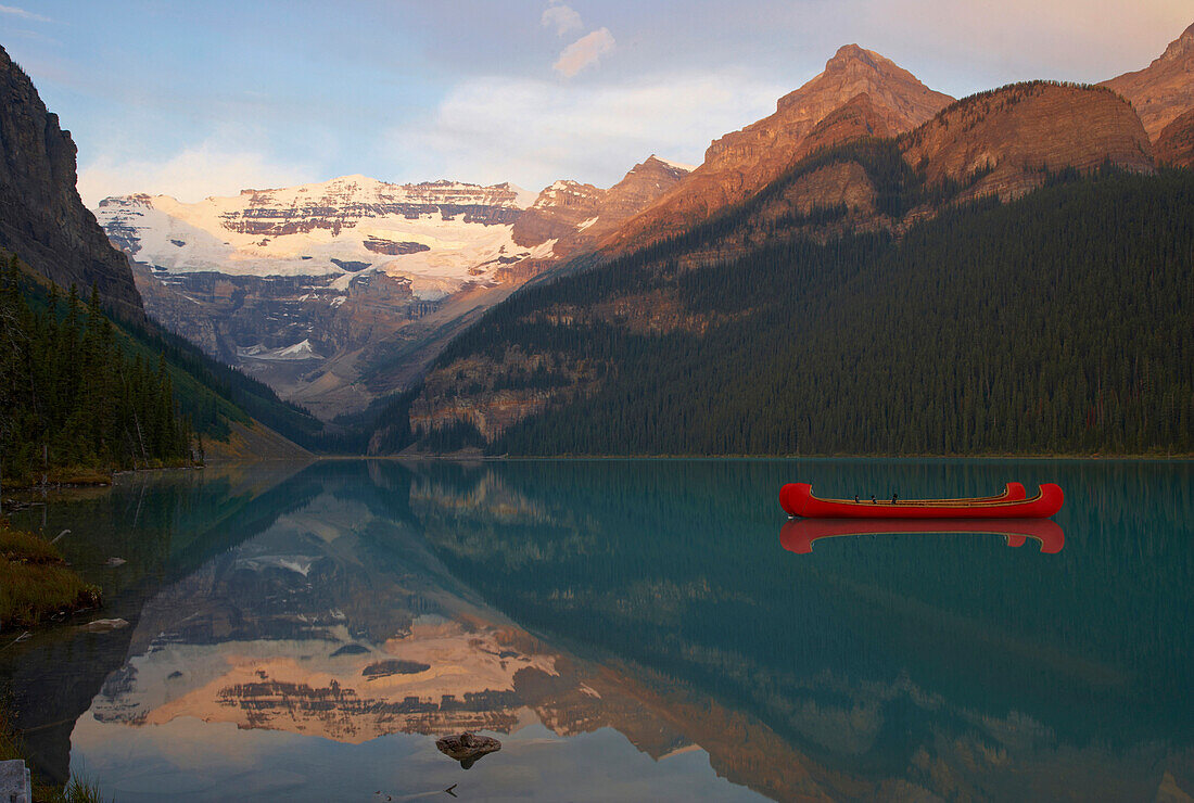 Victoria Glacier and canoes on Lake Louise, Sunrise, Banff National Park, Rocky Mountains, Alberta, Canada