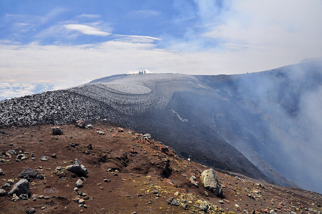 Mountain climbers and smoke at crater of volcano Villarrica, Strato volcano, sunset, National Park Villarrica, Pucon, Región de la Auracania, Region Los Rios,  Patagonia, Andes, Chile, South America