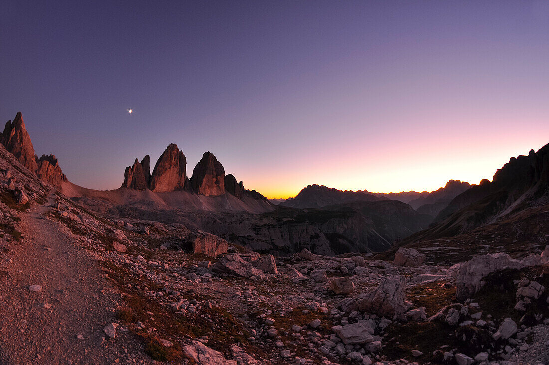 Sunset and moon over Paternkofel and Three Peaks (Drei Zinnen), scree and boulder field, Val Pusteria Valley, Sesto, Dolomites, South Tyrol, Veneto, Alto Adige, Three Peaks (Tre Cime di Lavaredo) Nature Park, UNESCO world heritage side, Italy, European Al