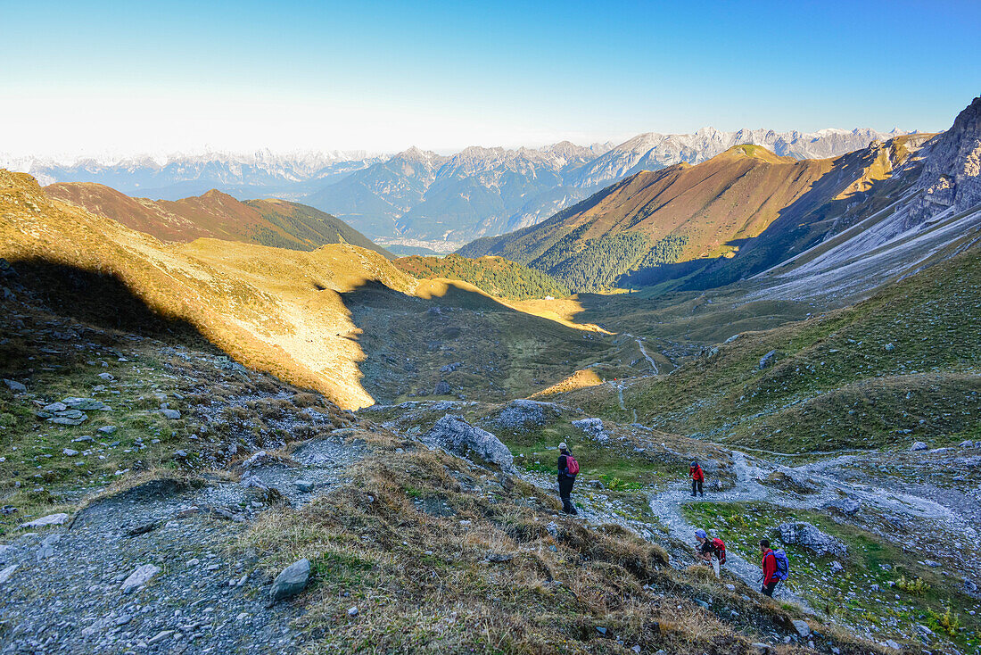 Hikers in morning light on hiking trail to Schlicker Seespitze and Gamskogel, Kalkkögel, Grinzens, Stubai valley, Hinteres Oberbergtal, Stubai Alps, Tyrol, Austria, European Alps, Europe