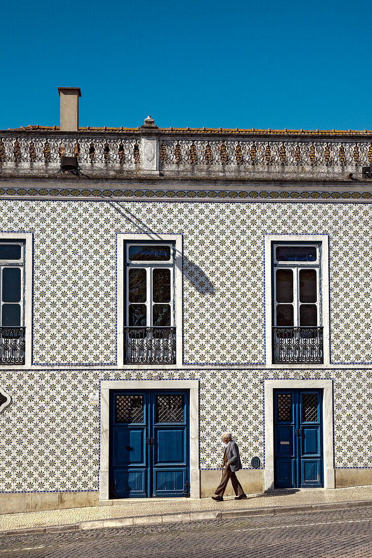 Old man in front of tiled house, Beja, Alentejo, Portugal