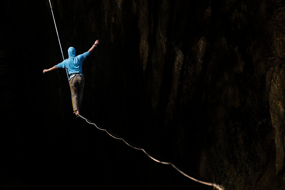 German slackliner Oliver Ross walks across a 113m long and 30m high Highline in Neubeuern, Bavaria, Germany.