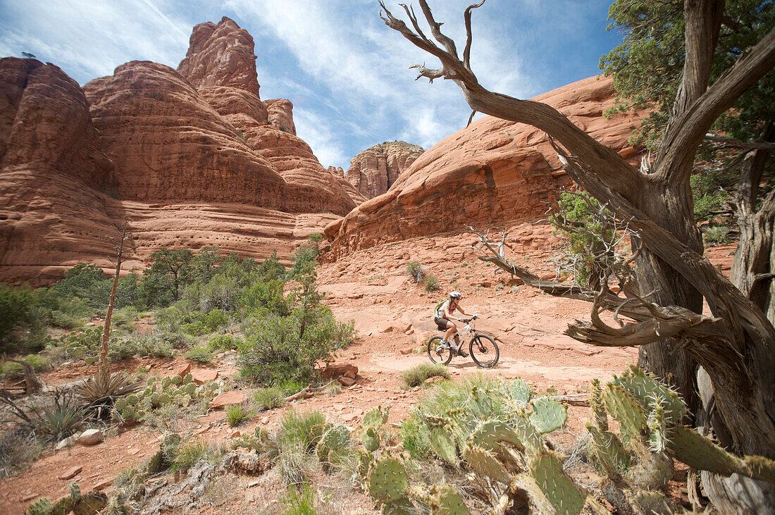 Woman rides the Submarine Rock Loop in South Sedona, Arizona. The trail has everything from slickrock to single track to stairs that lead to Submarine Rock.