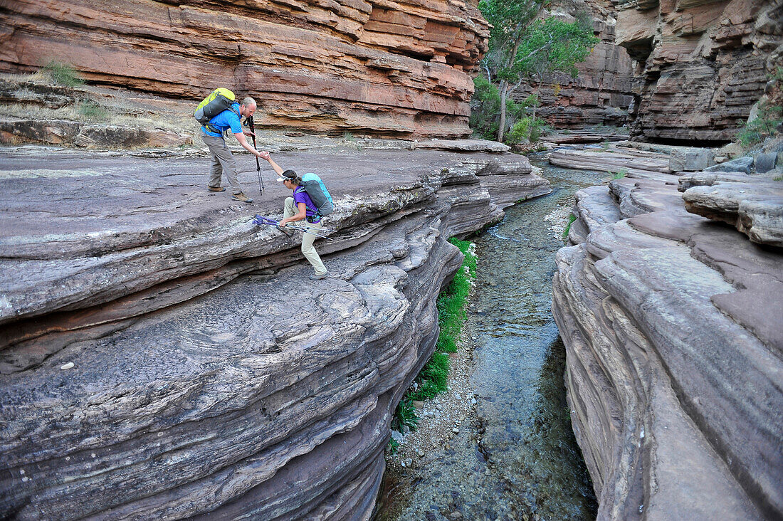 Hikers walk along Deer Creek Narrows in the Grand Canyon outside of Fredonia, Arizona November 2011.  The 21.4-mile loop starts at the Bill Hall trailhead on the North Rim and descends 2000-feet in 2.5-miles through Coconino Sandstone to the level Esplana