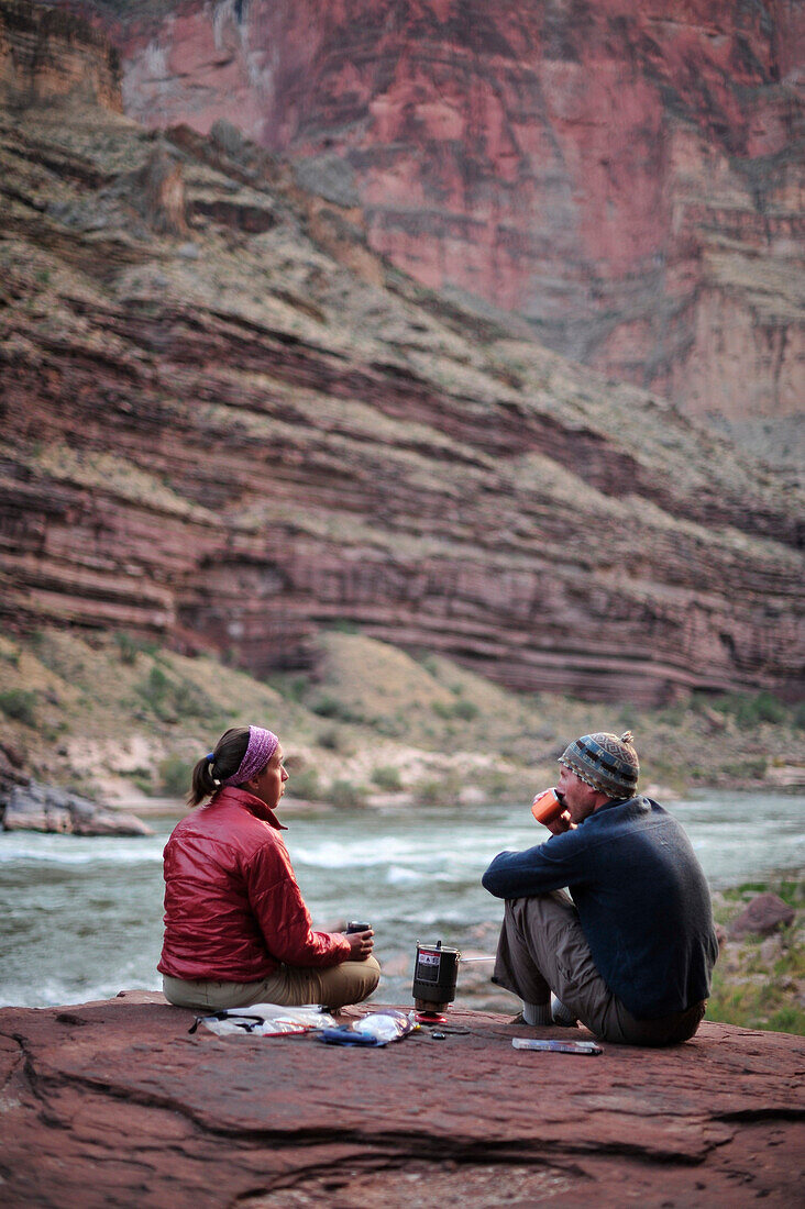 Hikers cook dinner on a cliff-pinched patio above camp and the Colorado River near Deer Creek Falls in the Grand Canyon outside of Fredonia, Arizona November 2011.  The 21.4-mile loop starts at the Bill Hall trailhead on the North Rim and descends 2000-fe