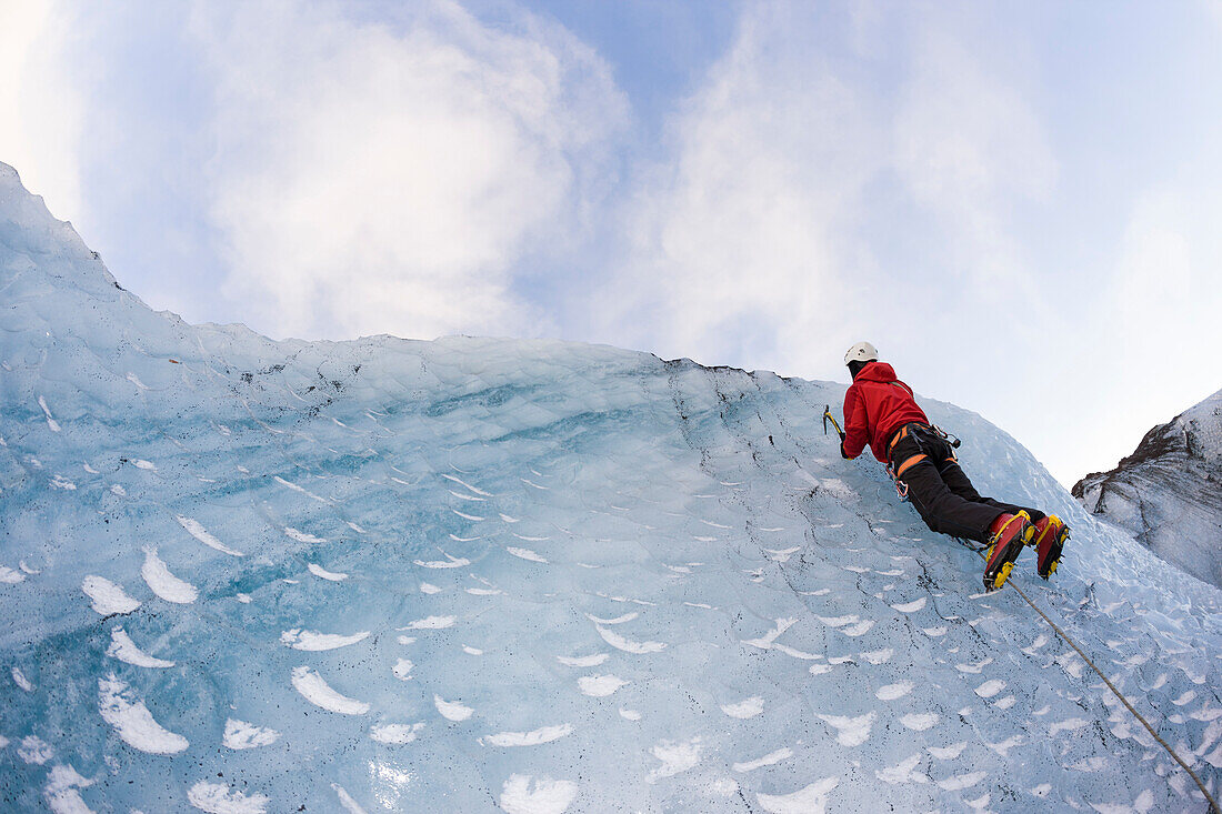 Climber on the icelandic glacier Solheimajokull during winter. South Iceland.