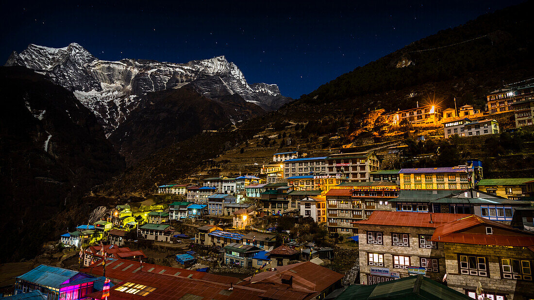 The lights of the Sherpa village of Namche Bazaar at night looking across to Kongde Ri mountain (6187m) on 30th November 2012, Sagarmatha National Park, Khumbu region, Nepal