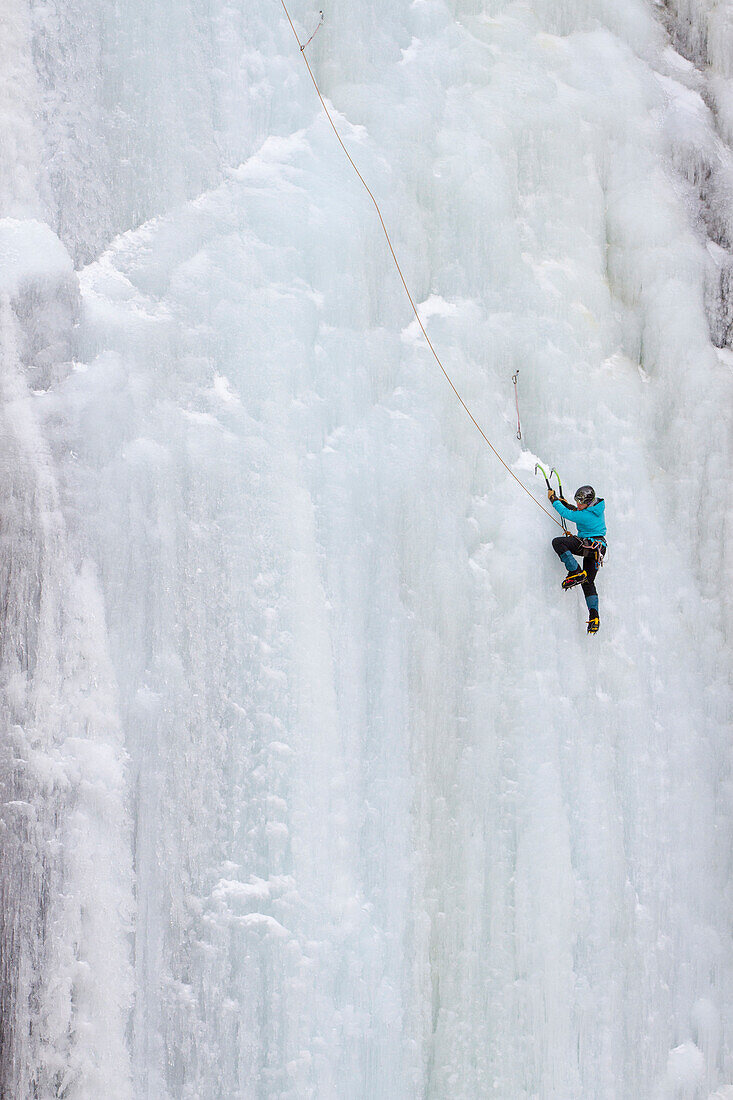 A  woman ice climbs on Blodgett Falls in the Bitterroot Mountains of Montana.