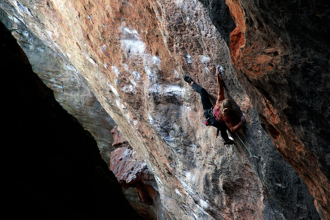 A climber scaling limestone cliffs in the jungle at Serra do Cipo, Minas Gerais, Brazil, South America