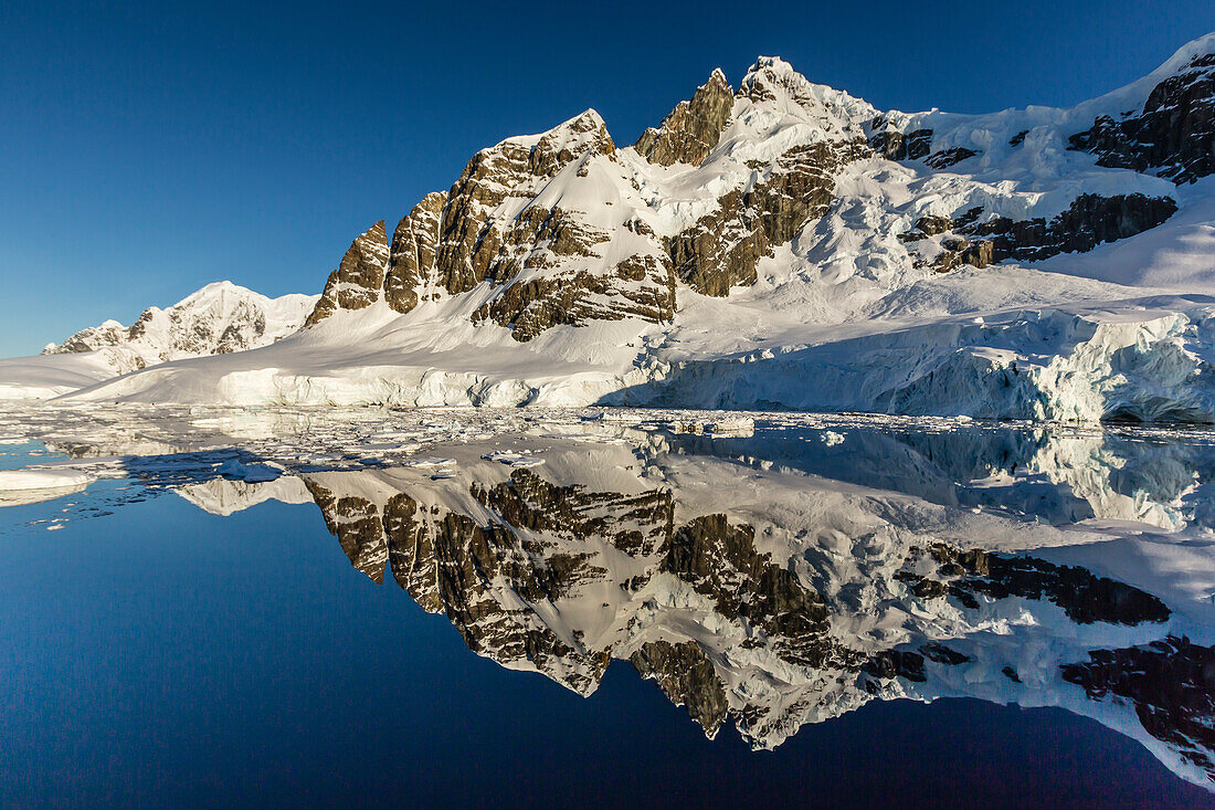 Reflections in the calm waters of the Lemaire Channel, Antarctica, Polar Regions