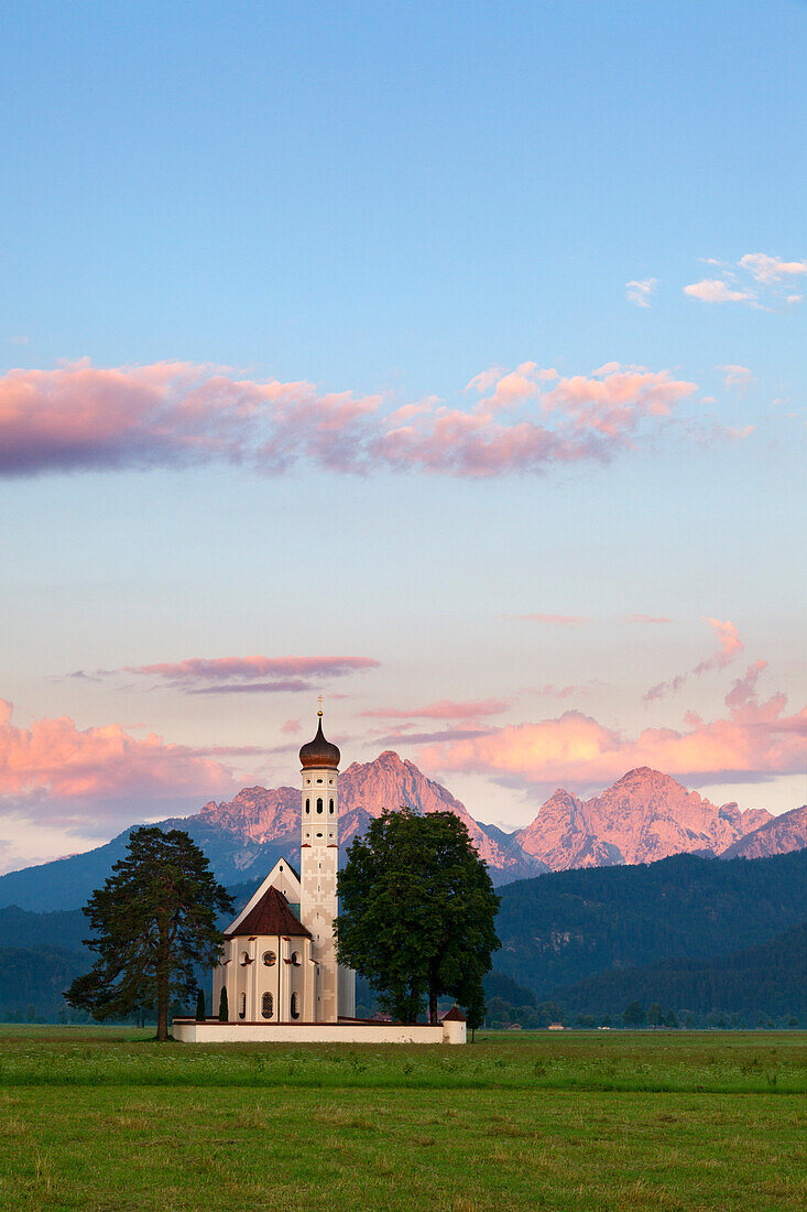 St Coloman pilgrimage church near Schwangau at dawn, view to Tannheimer Berge, Allgaeu, Bavaria, Germany