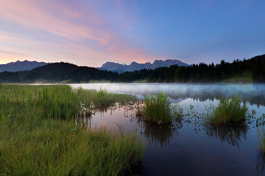 Morning fog at lake Geroldsee, view to Soierngruppe and Karwendel, Werdenfels region, Bavaria, Germany