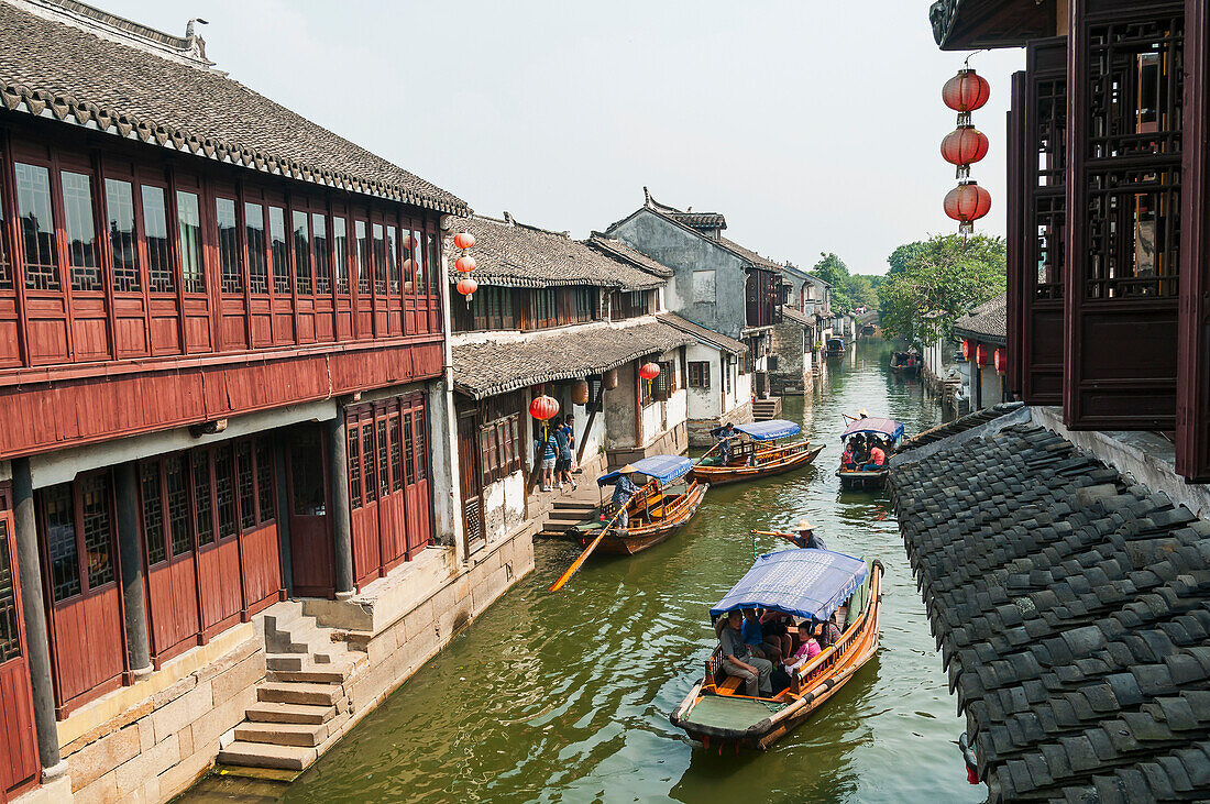 Channels the boatmen drive their boats as Venetia, beautiful traditional Chinese architecure as background, ZhouZhuang, Shanghai, China