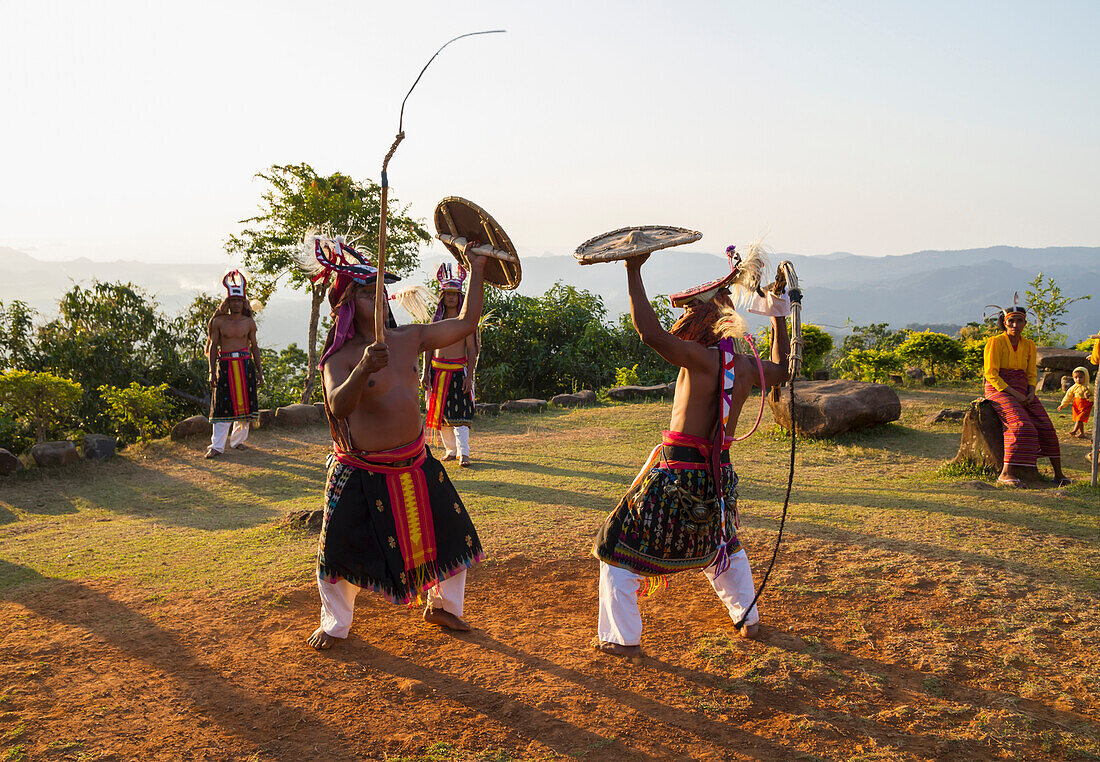 Manggarai men wearing traditional headdress wrapped with cloth using shields and bamboo whips in a caci, a ritual whip fight, Melo village, Flores, East Nusa Tenggara, Indonesia