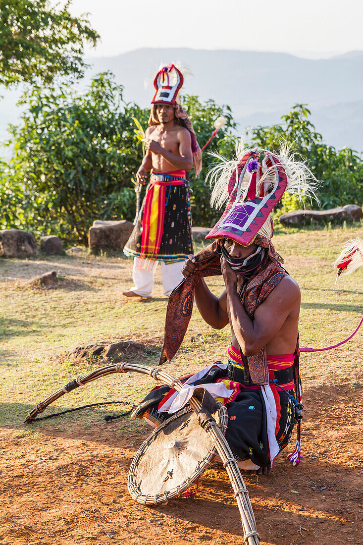 Manggarai men wearing traditional headdress wrapped with cloth and wielding shields and bamboo whips before a caci, a ritual whip fight, Melo village, Flores, East Nusa Tenggara, Indonesia