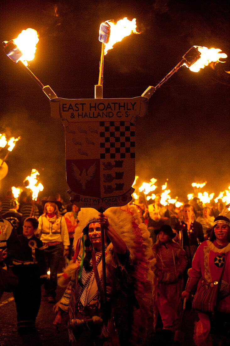 People dressed as American Indians walking in procession for East Hoathly Bonfire Night, East Sussex, England