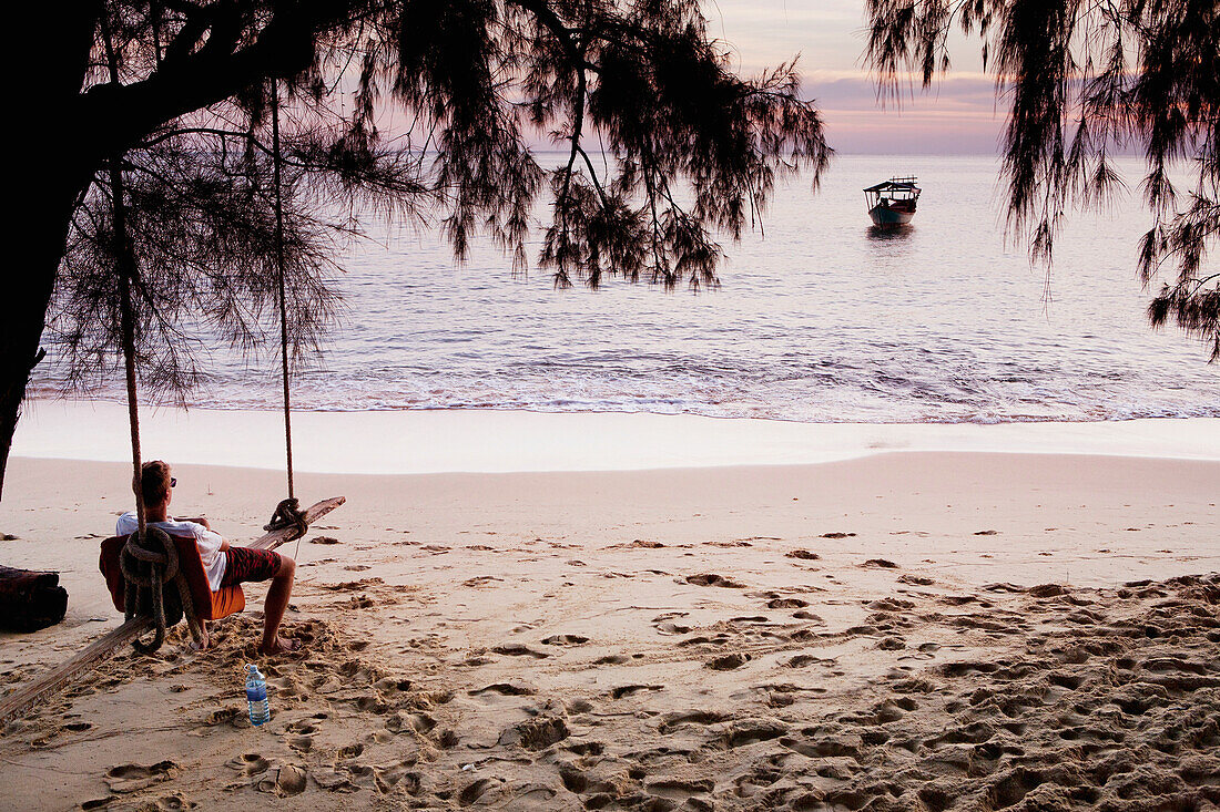 Relaxing on a beach swing, Bamboo Island, Cambodia