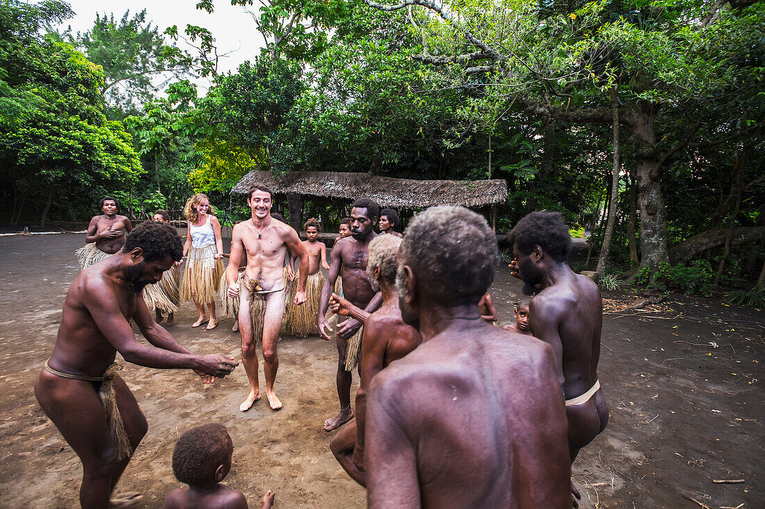 Tourist dances with men at Yakel Village, Tanna Island, Vanuatu