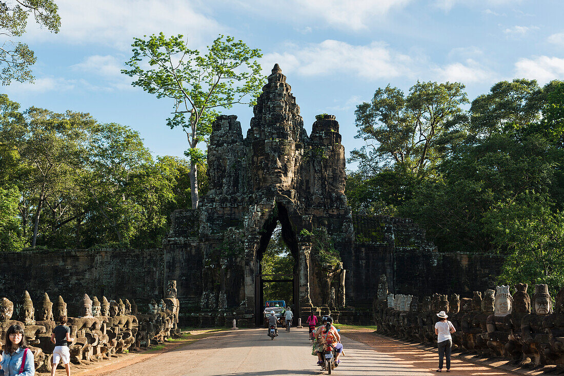 'South gate of Angkor, connecting Bayon Wat and Angkor Wat, in the laterals many buddhas are holding a big snake, the gate is made by a tower with four buddha faces; Siem Reap, Cambodia'