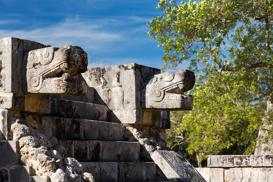 'Two large Ancient Mayan stone carved Jaguar heads above stone steps to a platform with blue sky; Chichen Itza, Yucatan, Mexico'