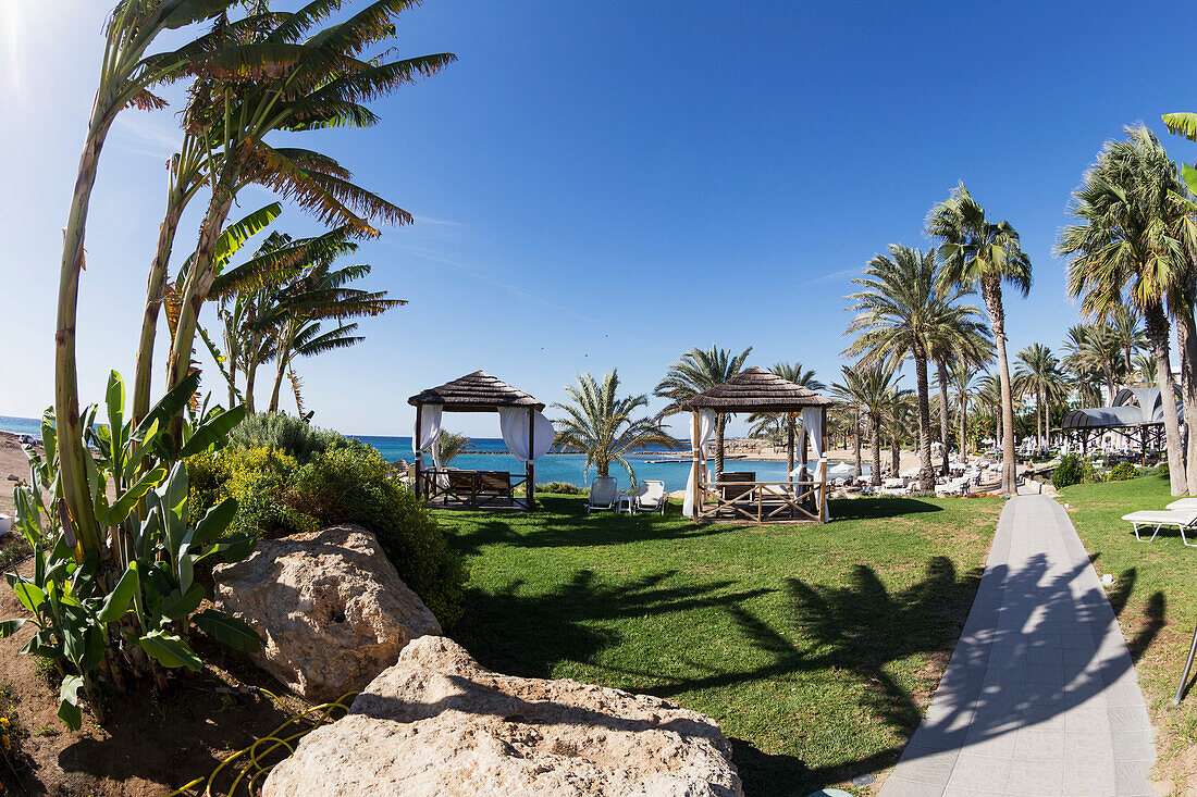 'Resort with palm tree and shelters along the waterfront; Geroskipou, Cyprus'