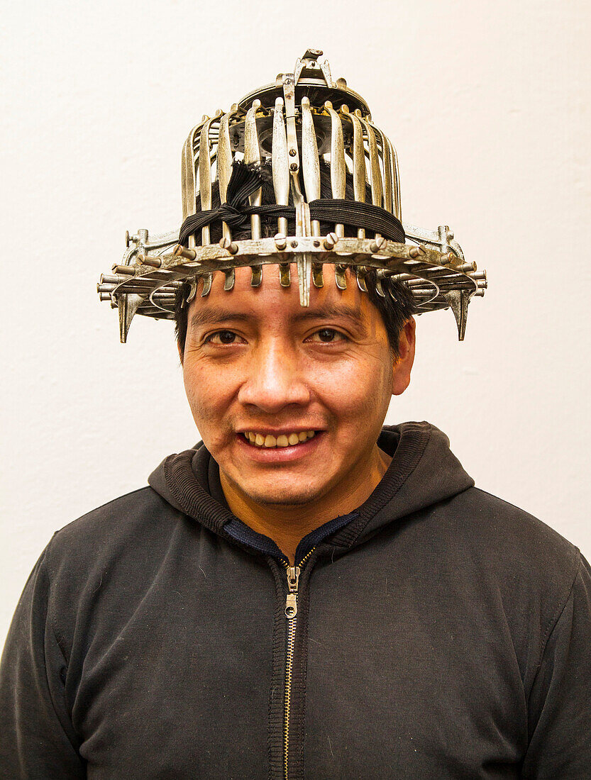 Man wearing  a haberdashers fitting instrument at the Barranco Panama Hat Factory, Cuenca, Azuay, Ecuador