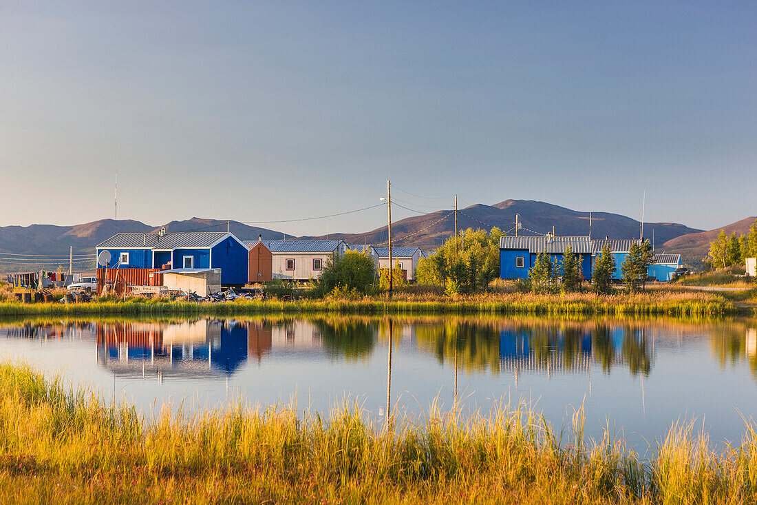Colorful houses in the village of Shungnak, along the bank of the Kobuk river on a calm sunny day, Arctic Alaska, Summer