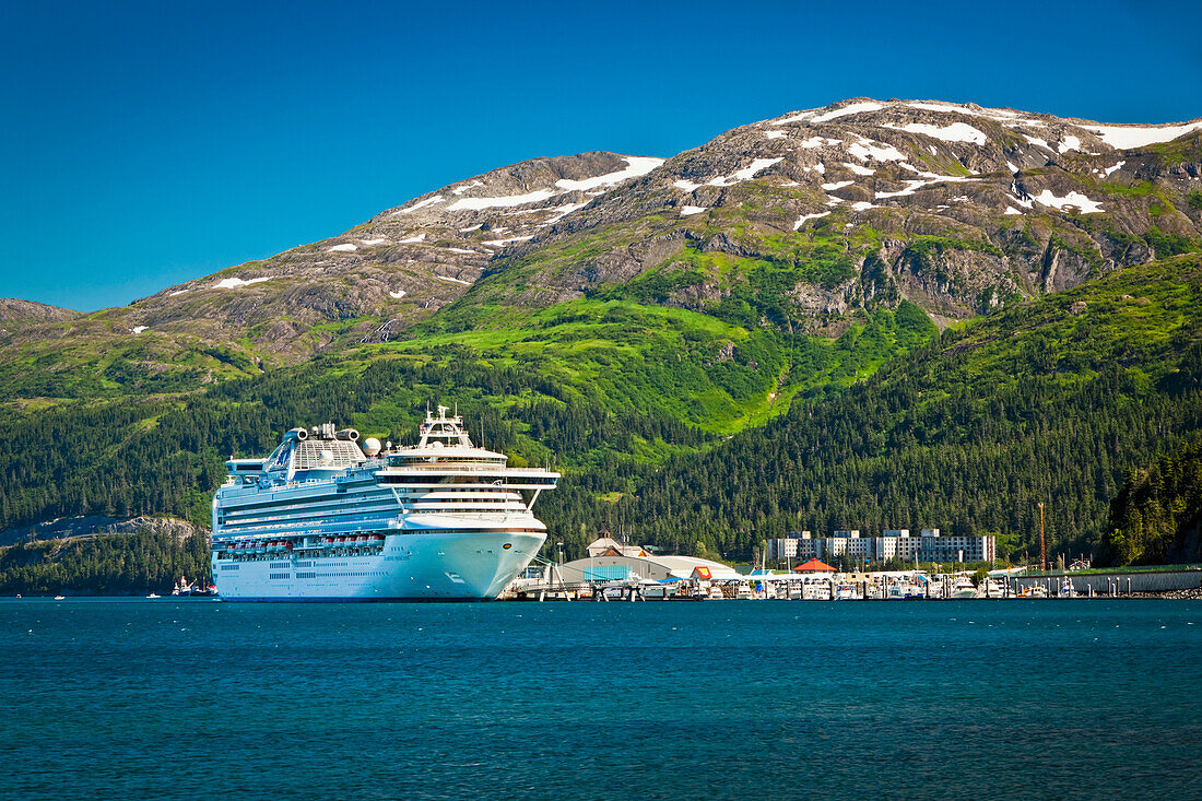 Cruise ship 'Diamond Princess' docked at the Port of Whittier surrounded by Chugach Mountains, Southcentral Alaska, Summer.