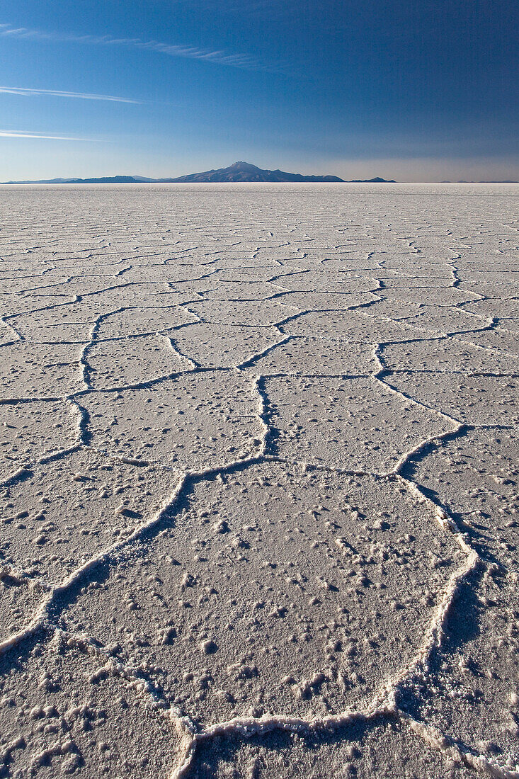 Volcano Tunupa on the horizon of the Salar de Uyuni, the biggest salt desert in the world, Oruro, Bolivia, South America