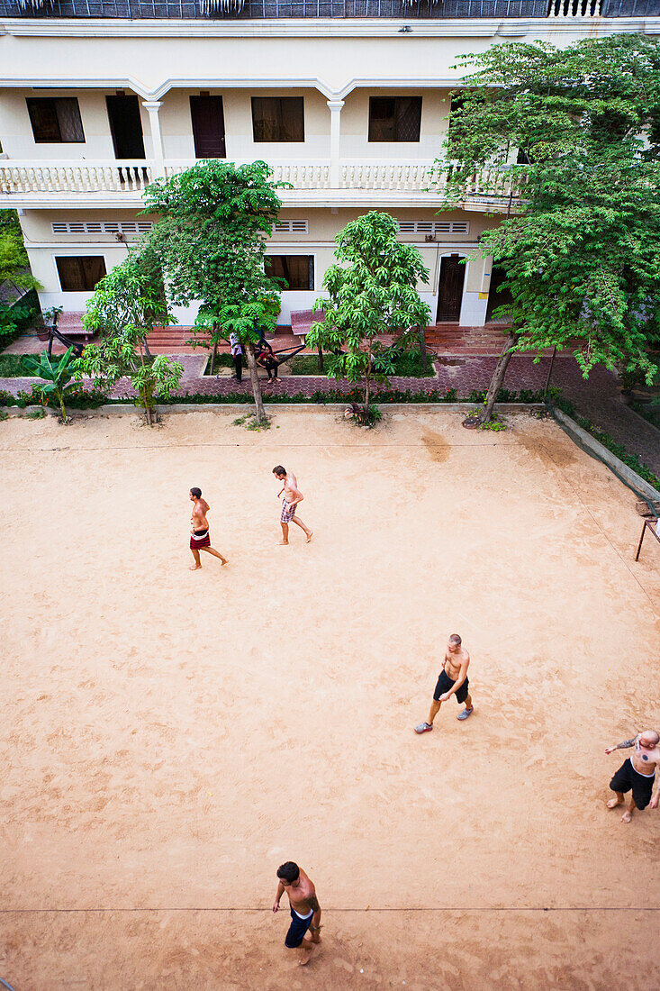 Locals play soccer on outdoor pitch, Siem Reap, Cambodia